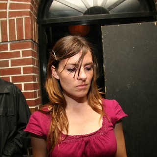 Young Woman at Late Night Party Looks Down