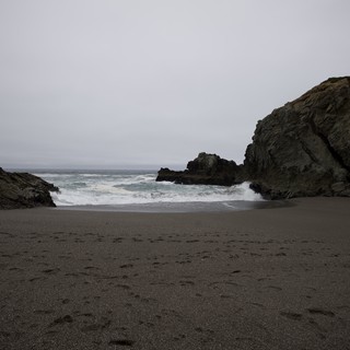 Moody Coastal Cove Framed by Ancient Sea Rocks