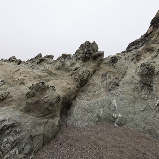 Jagged Coastal Cliffs Rise Against Overcast Sky