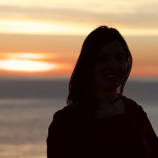 Smiling Silhouette Against a Golden Sunset Sea