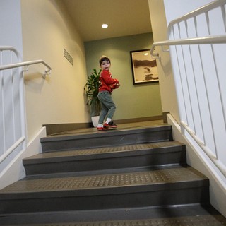 Young Boy Climbing Stairs in Modern Interior