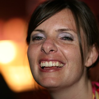 Joyful Woman Laughing in Warm Ambient Light