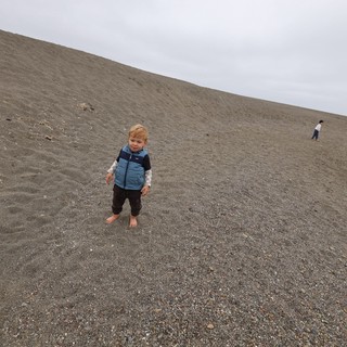 Barefoot Toddler Conquering a Coastal Sand Dune