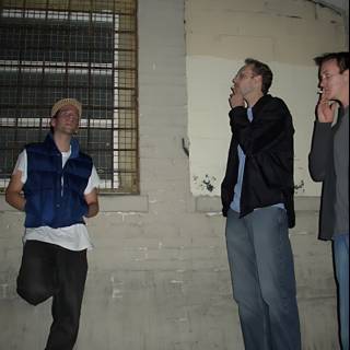 Three Men Posing in Front of a Brick Wall
