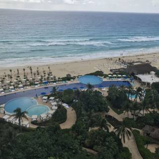 Aerial View of Luxurious Resort Pool and Beach