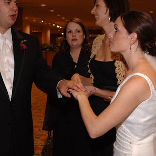 Bride and Groom Exchange Rings at Wedding Reception
