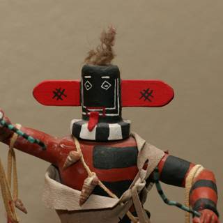 Native American Figurine with Red and Black Headdress
