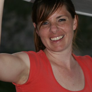 Joyful Woman Holding Up a White Panel Outdoors