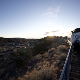 Sunset Train Journey Through Desert Landscape