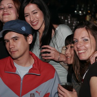 Friends Posing Together at a Nightclub Bar