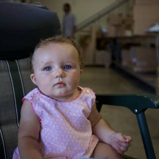 Tiny Tot Takes a Seat in a Warehouse
