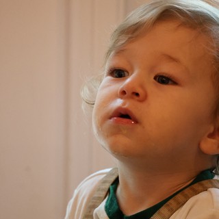 Curious Toddler with Blonde Curls Looking Up