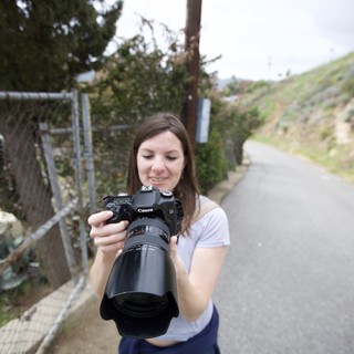 Photographer Reviewing Shots on Canon DSLR Outdoors