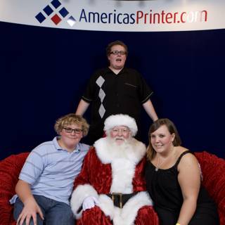 Santa Claus Strikes a Pose with Three Guests at 2008 APC Xmas Party