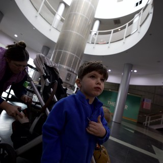 Young Boy in Blue Hoodie at Science Center