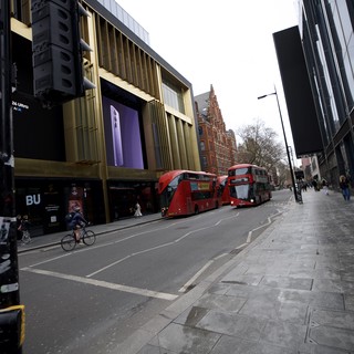 Modern Shopping District with Red Double-Decker Buses