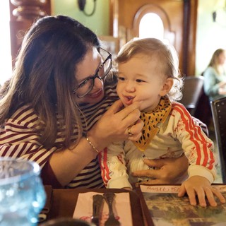 Mother and Child Sharing a Sweet Moment at Restaurant