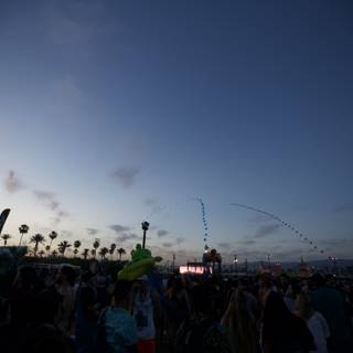 Crowd at Coachella under a Flare-Lit Sky