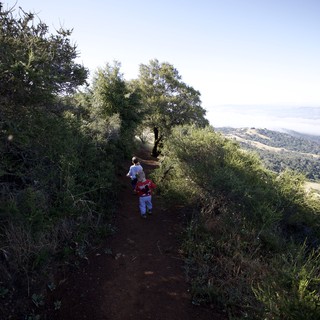 Young Explorers Hiking Ridge Trail Above the Clouds