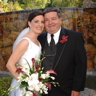 Bride and Groom Celebrate by Waterfall Feature