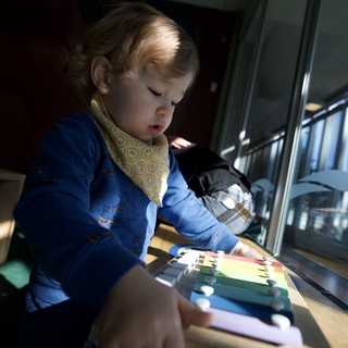 Young Child Exploring Colorful Educational Toy at Home