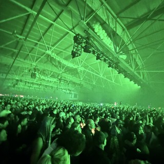 Massive Crowd Under Green Lights at Electronic Music Concert