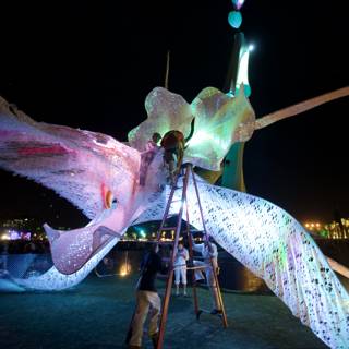 Illuminated Bird Sculpture Takes Flight at Night