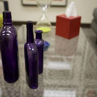 Purple Bottles on Glass Table