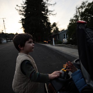 Child with Toy at Dusk in Suburban Neighborhood