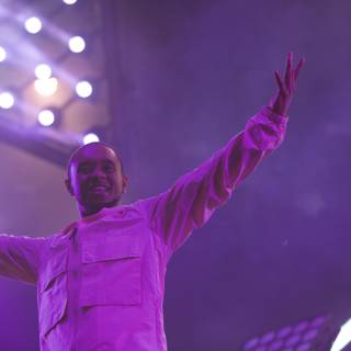 Man in White Shirt Basks in Purple Spotlight