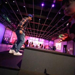 Dynamic Breakdancer at Baby Rave Under Purple Lights