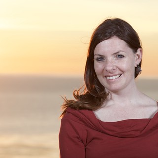 Smiling Woman at Golden Hour Coastal Sunset