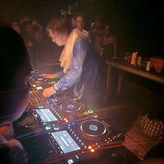 DJ Performance in Atmospheric Club Setting