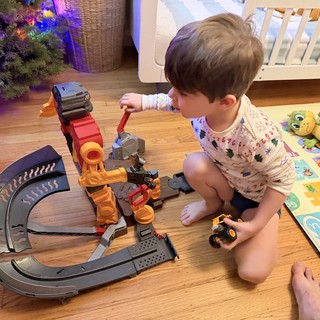 Toddler Playing with Monster Truck Toy Track Set at Christmas