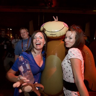 Party Guests Pose with Giant Inflatable Toy