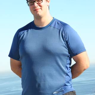Dave B enjoying the ocean view with his blue shirt and glasses on