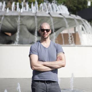 Man Strikes a Pose in Front of Majestic Fountain
