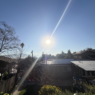 Suburban Home with Solar Panels at Golden Hour
