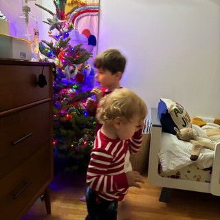 Children Dancing by Christmas Tree in Striped Pajamas