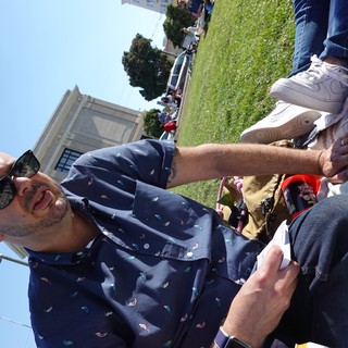 Man Relaxing at Outdoor Gathering in Park