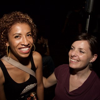 Two Women Smiling Together at Nightclub Event
