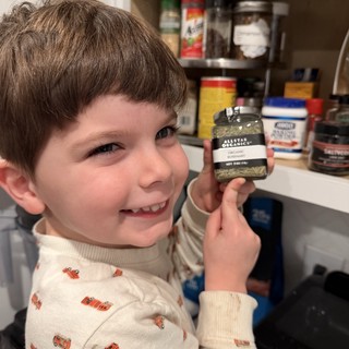 Young Boy Helping in Kitchen with Organic Rosemary
