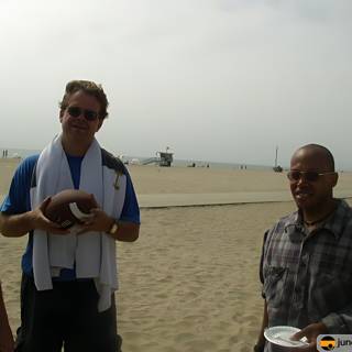 Three Men Enjoying Beach Football Game