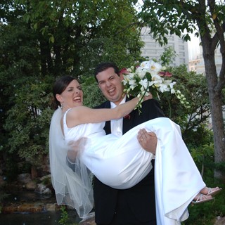 Joyful Groom Carries Laughing Bride on Wedding Day