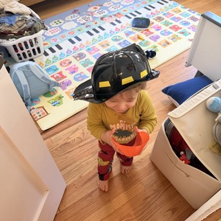 Young Child Playing Firefighter at Home