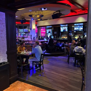 Modern Sports Bar Interior with Vibrant Red Accent Lighting