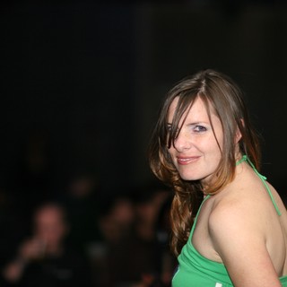 Woman in Green Halter Glances Back at Camera