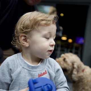 Toddler with Curly Hair Playing with Blue Toy