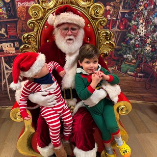 Two Children Visit Santa in His Workshop Throne