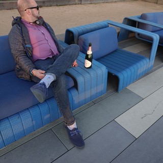 Man Relaxing with Champagne on Blue Furniture